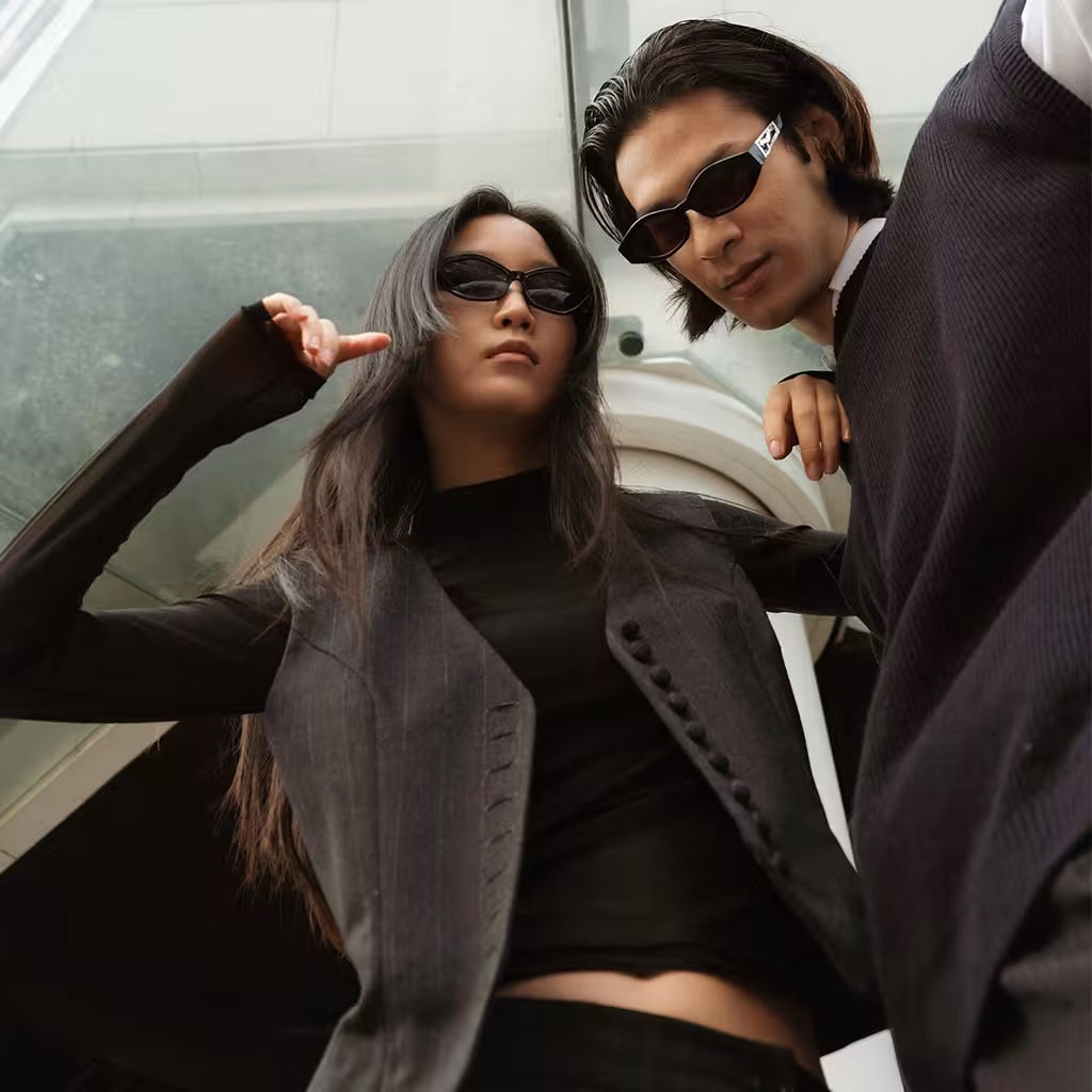 A girl and a guy wearing sunglasses